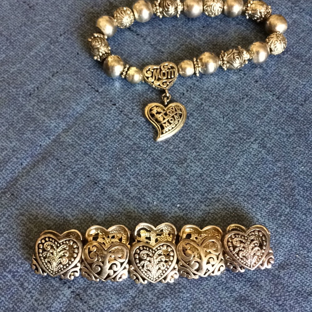 2 silver colored bracelets